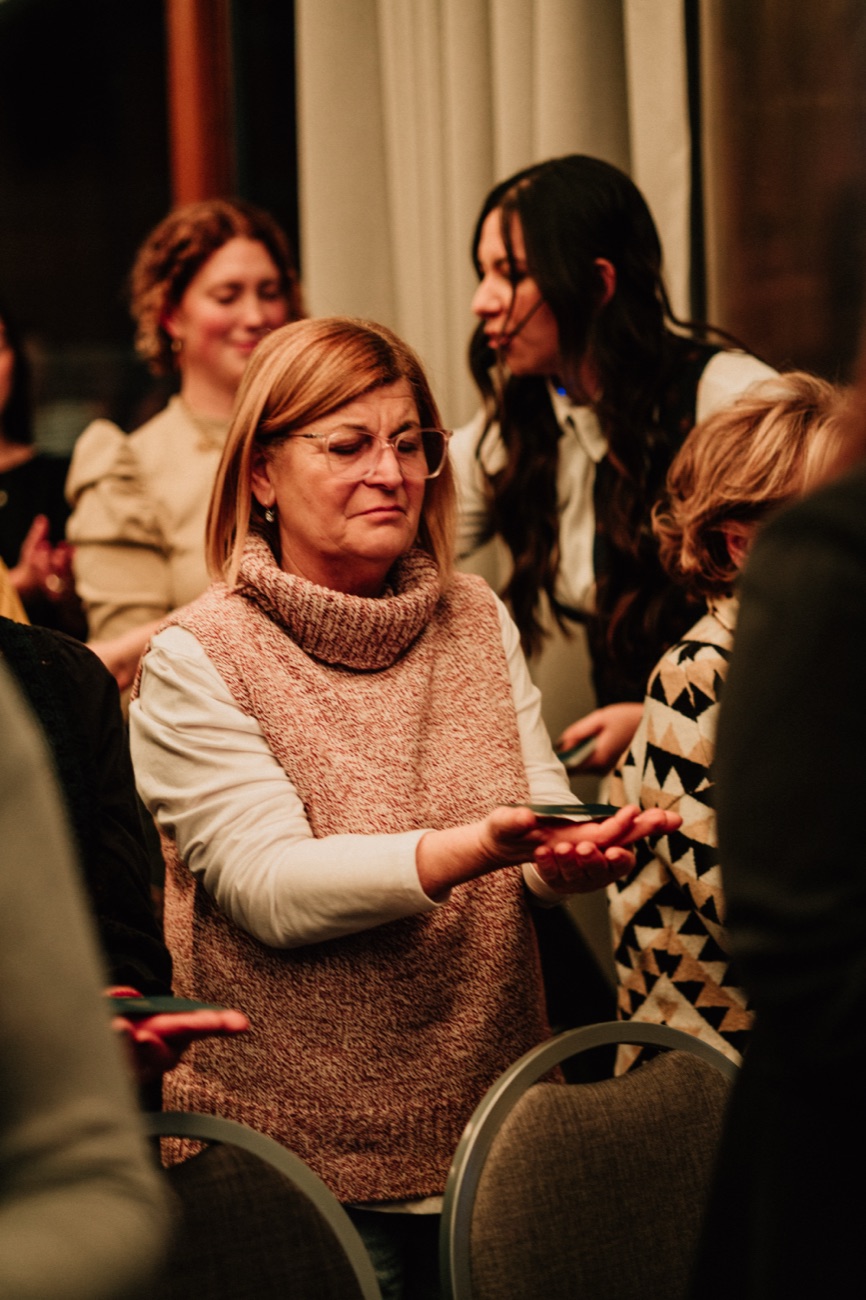 Una asistente de pie entre las sillas durante un ejercicio del encuentro